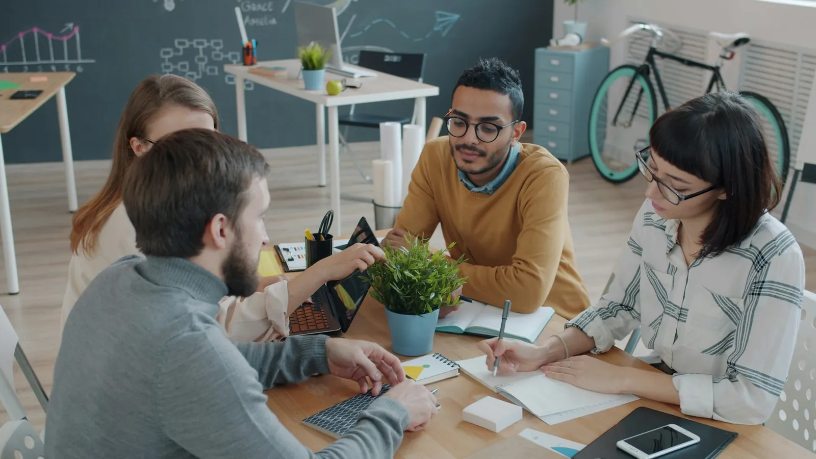 A startup team working around a shared table